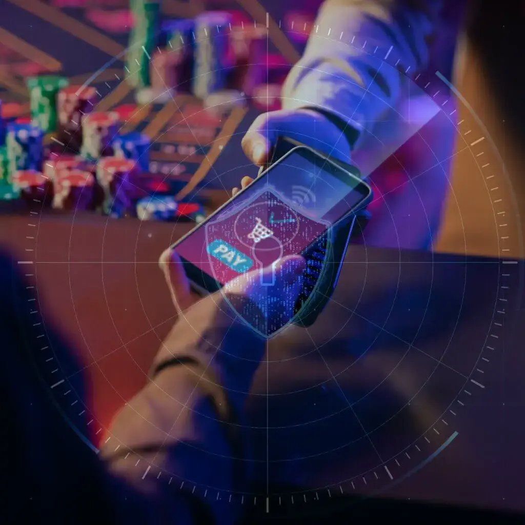 Smartphone making a digital payment at a casino table with chips in the background