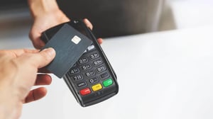 Credit card being tapped on a payment terminal