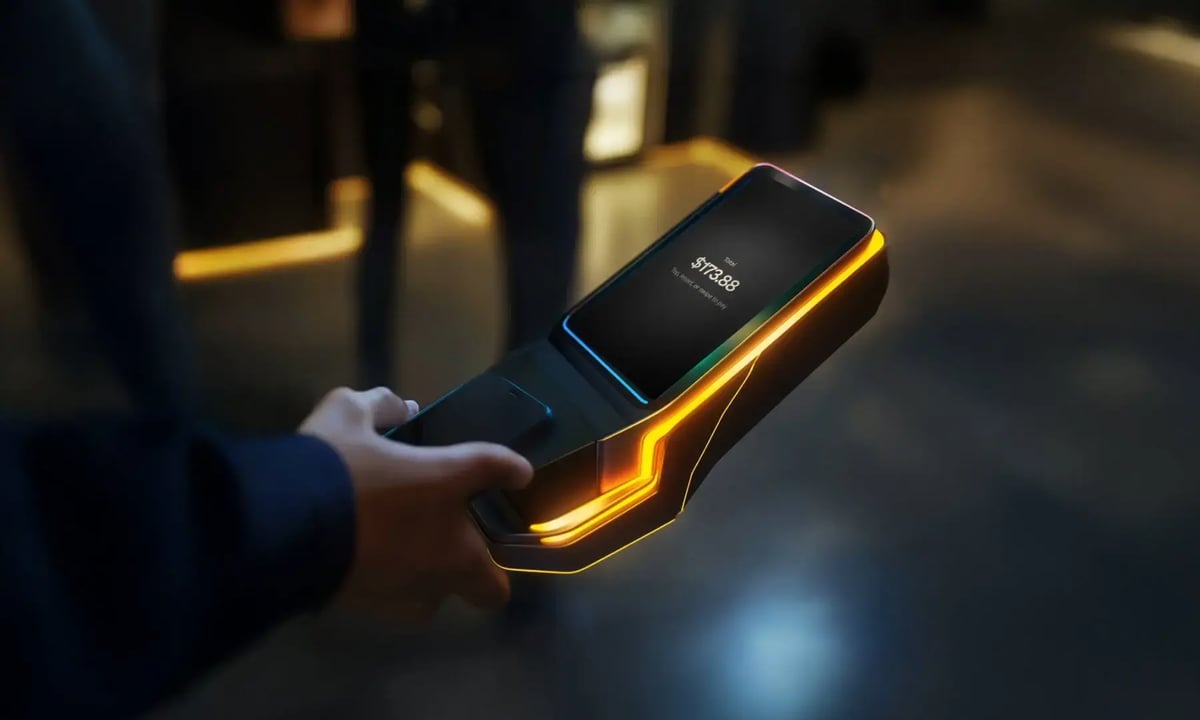 Modern mobile payment terminal held in a man's hand