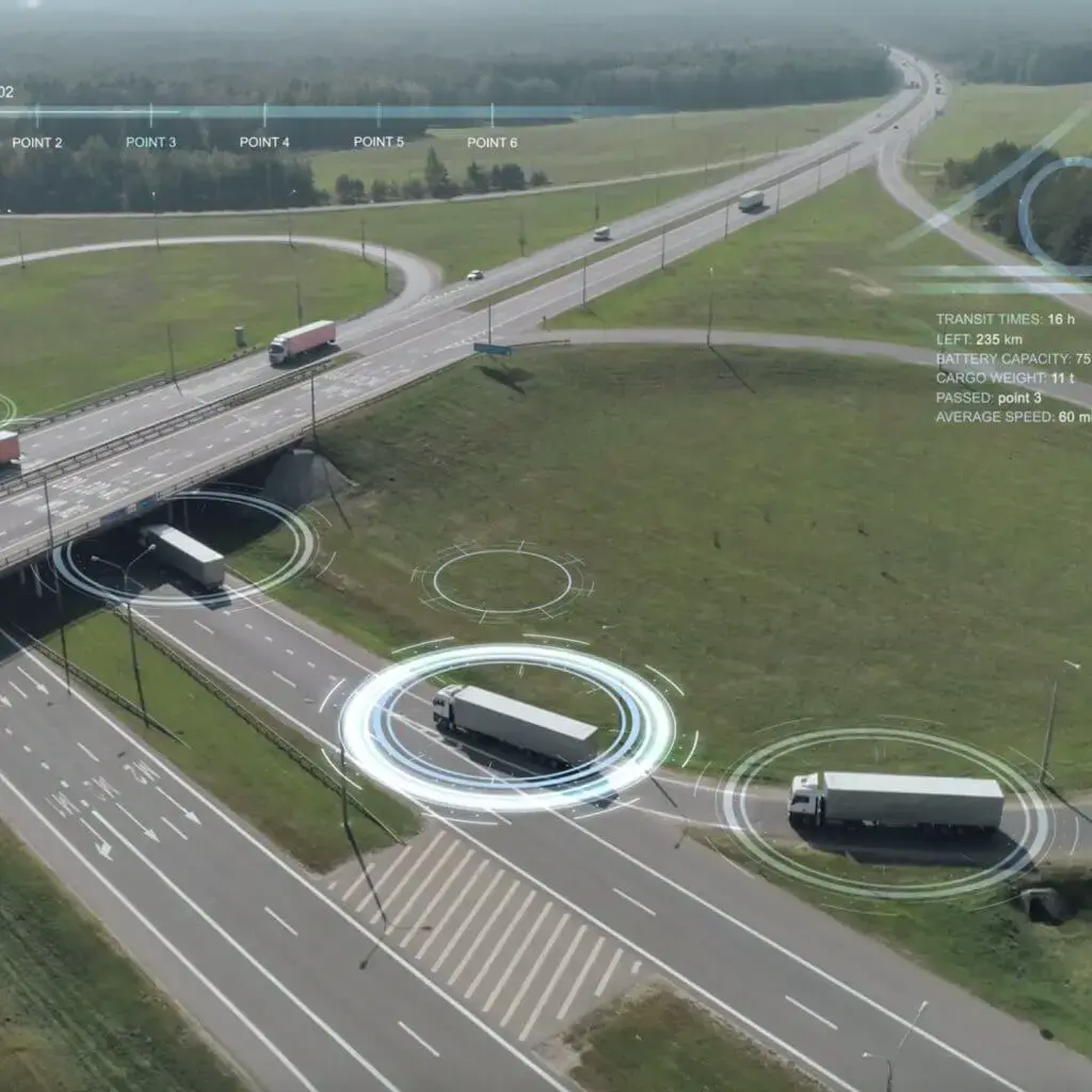 Aerial view of trucks with digital tracking overlays on a highway